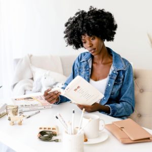 Woman reading book in home.